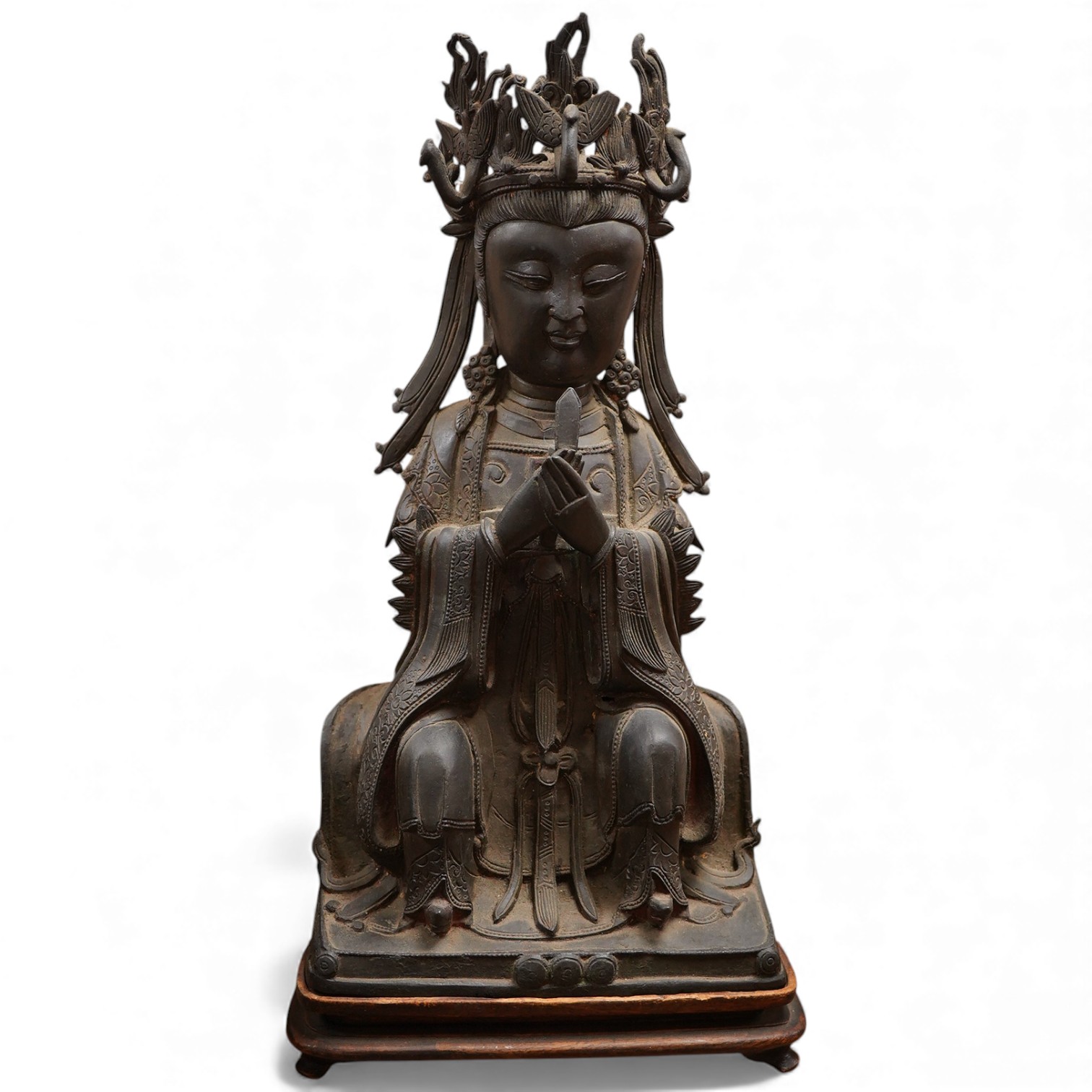 A Chinese late Ming bronze seated figure of Xi Wangmu, early 17th century (on stand). 34.5cm high not including stand.